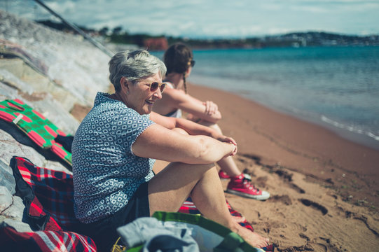 Senior woman and adult daughter on the beach