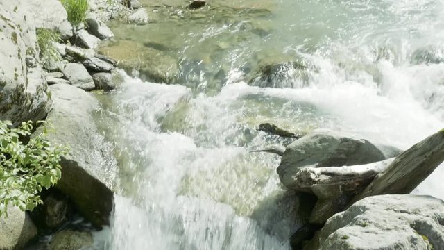 SLOW MOTION Watching a waterfall on a hike in Auron, France.