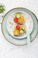 Vegetable mini toast farmer market assorted white baguette vegetables with fish riyette decorated with mini green daikon. Top View