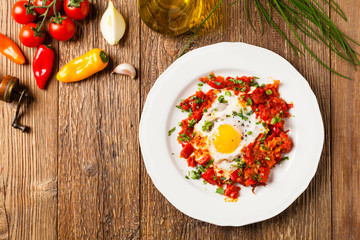 Shakshouka, dish of eggs poached in a sauce of tomatoes, chili peppers, onions