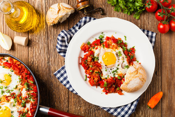 Shakshouka, dish of eggs poached in a sauce of tomatoes, chili peppers, onions