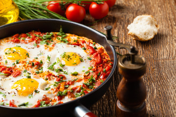 Shakshouka, dish of eggs poached in a sauce of tomatoes, chili peppers, onions