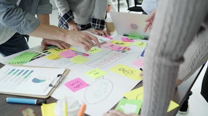 Group of casually dressed business people discussing ideas in the office. Creative professionals gathered at the meeting table for discuss the important issues of the new successful startup project.