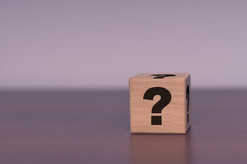 Wooden cube with question mark Business concept