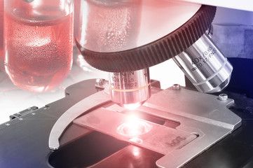 close up shot of microscope at the blood laboratory take with selective color technique and art...