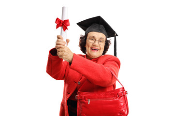 Joyful senior lady with a diploma and a graduation hat