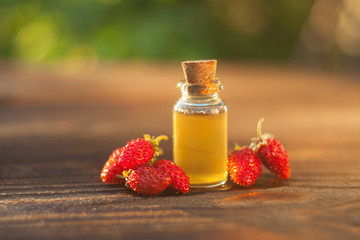 Essence of Wild strawberry on table in beautiful glass jar