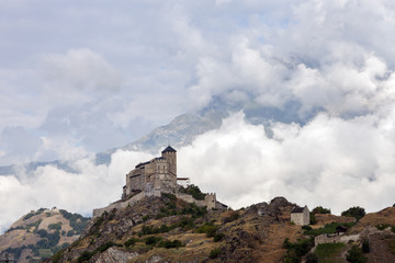 castle and church on hill above swiss town of sion in the rhone valley