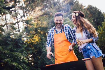 Beautiful woman and handsome man having barbecue