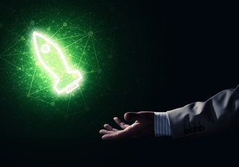 Man palm presenting Rocket web icon as technology concept