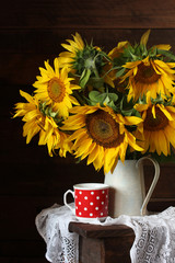 still life with a bouquet of sunflowers and a red Cup
