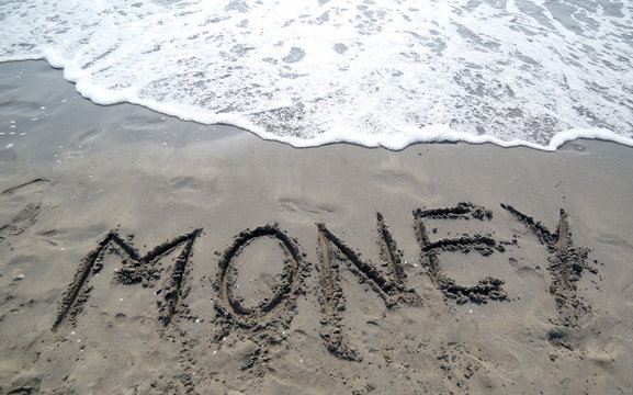 reat text MONEY that is canceled by the sea wave on the sandy be