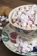 Beautiful vintage cup of homemade hot chocolate or cocoa with marshmallows and oat cookies, wooden table. Warm sweet drink