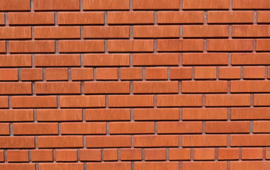 Brick wall of red color, wide panorama of masonry.