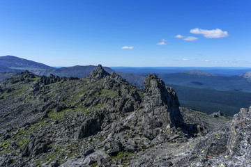 Fototapeta na wymiar beautiful mountain landscape with spectacular black rocks in a blue atmospheric haze in the vicinity of mount Konzhakovskiy Kamen