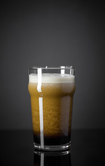 Draft Nitrogen Fresh and Creamy Black Stout Beer Pint over Black Background