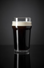 Draft Nitrogen Fresh and Creamy Black Stout Beer Pint over Black Background