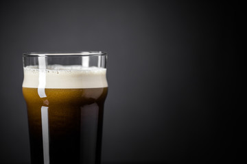Draft Nitrogen Fresh and Creamy Black Stout Beer Pint over Black Background