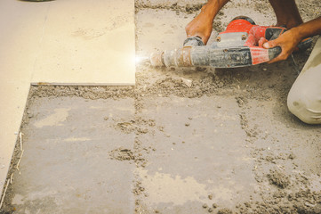 Men workers are extracting tiles because they are tiling wrong.