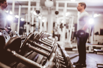 Interior of gym with man training