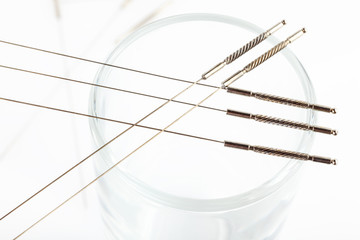 Silver needles for traditional Chinese medicine acupuncture. Close-up. White background.