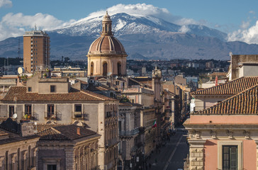 View on via Etnea in Catania. Dome of Catania and the main street with the background of volcano Etna, Sicily, Italy. Catania the UNESCO World Heritage.
