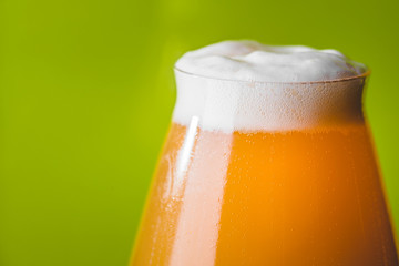 NEIPA Hop Bomb Beer over Green Background