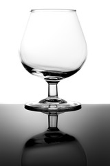 Empty Snifter Tasting Glass and Reflection Isolated on White