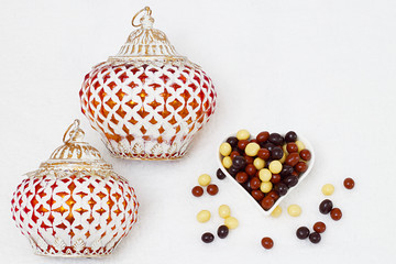 Eid Mubarak greeting with Eid Al Adha sacrifice festival, Islamic Arabic candle and sweet chocolate sugars