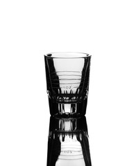 Fototapeta na wymiar Empty Alcohol Measuring Glass and Reflection Isolated on White