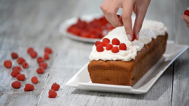 Cake with raspberries and mint leaves.