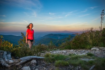 Fototapeta premium Young beautiful woman on mountain trail