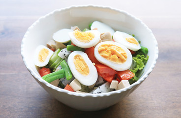 Diet menu. Healthy salad of fresh vegetables and egg on a bowl