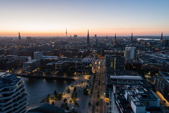 Aerial view of the harbor district, the concert hall "Elbphilharmonie" and downtown Hamburg, Germany, at dusk. Panorama.