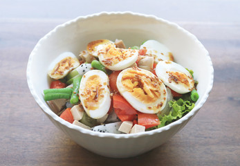 Diet menu. Healthy salad of fresh vegetables and egg on a bowl