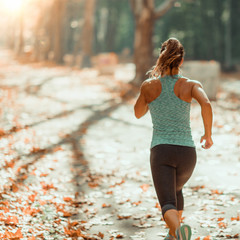 Woman Jogging Outdoors in The Fall