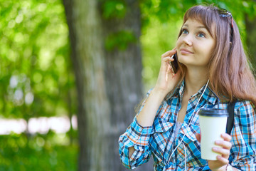 Fototapeta premium woman talking on phone in summer park.