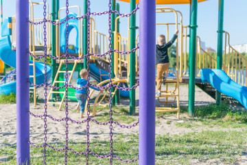 Fototapeta na wymiar Playground with children playing in summer.