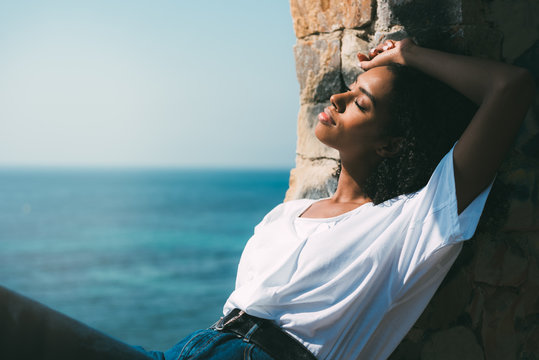 Woman sitting contemplating the sea view
