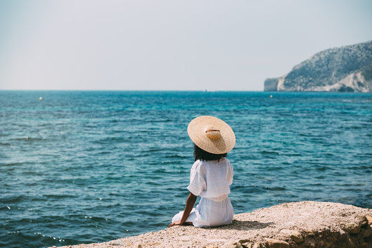 Black woman with straw hat enjoying the views