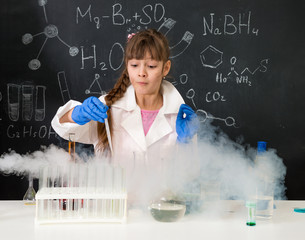 excited schoolgirl in fume after chemical experiment 