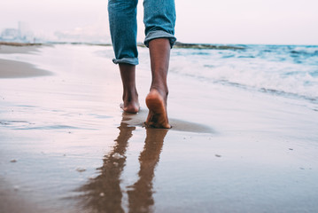 woman walking on the beach barefoot