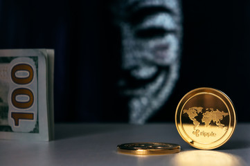 Ripple XRP coins and american dollars with Anonymous hacker face mask on background. Cryptocurrency security concept