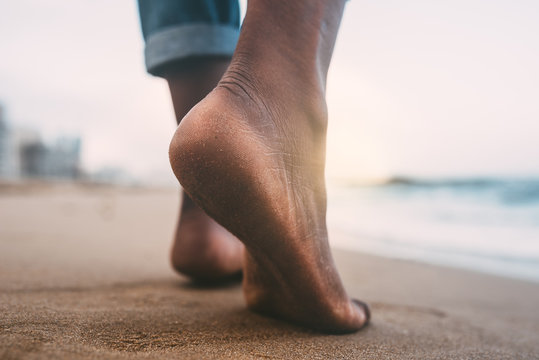 woman walking on the beach barefoot