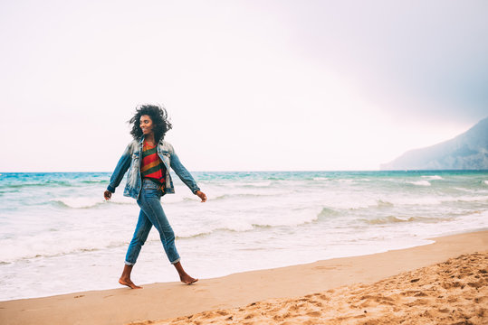 Woman Walking On The Beach Barefoot