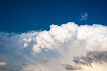 Naklejka na ściany i meble white storm cloud against a blue sky. close up