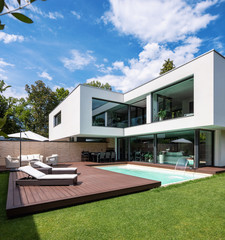 Exterior modern white villa with pool and garden