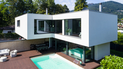 Exterior modern white villa with pool and garden