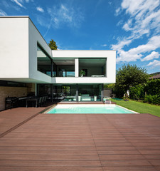 Exterior modern white villa with pool and garden