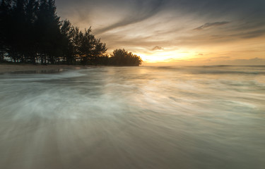 sunset seascape with waves trails. soft focus due to slow shutter and water movement.